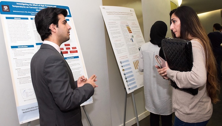 A student discusses his poster at QNRF's 9th Annual UREP competition